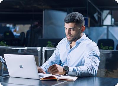 Eric Merlin working on a laptop in an office environment