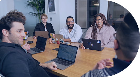 People in a meeting collaborating around a table